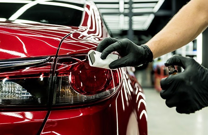 System X ceramic coating applied to the rear quarter of a red sedan