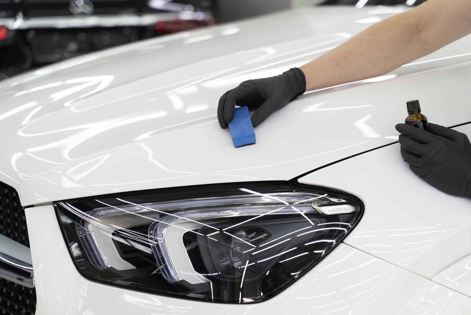 System X ceramic coating applied to a white Mercedes hood and headlight