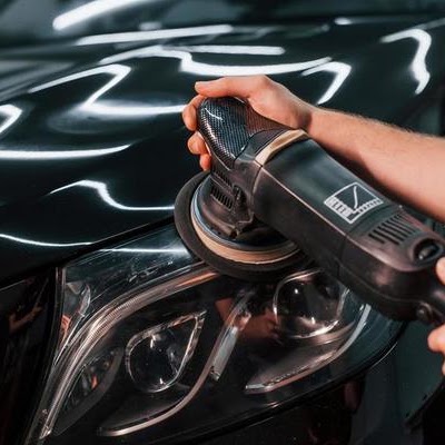 Machine polishing paint enhancement on a black car hood